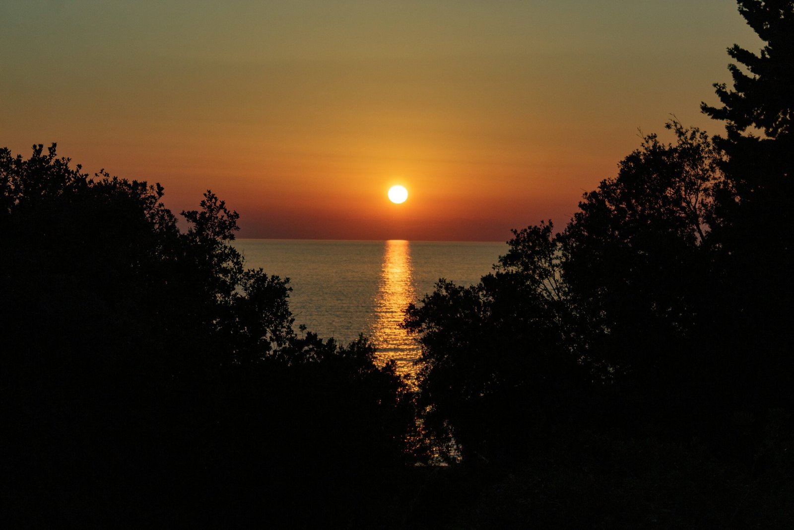 the sun is setting over a body of water